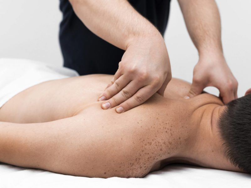 physiotherapist-massaging-male-patient-s-back-min physiotherapist-massaging-male-patient-s-back-min